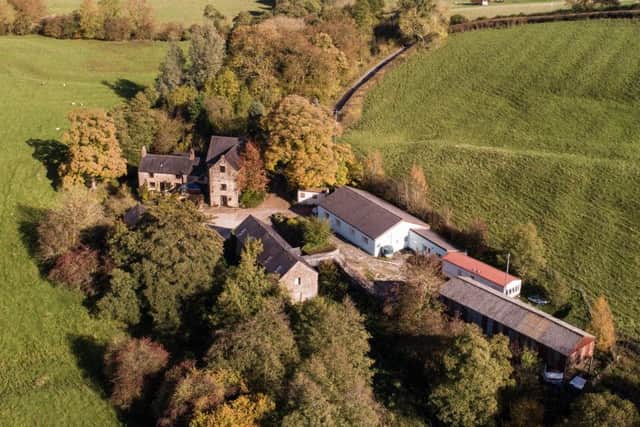 Aerial view of the property and outbuildings